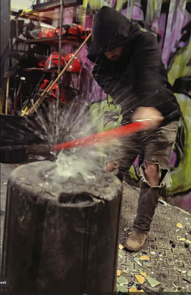 Guest smashing glass with a Rage Saber at Radicals Rage Rooms