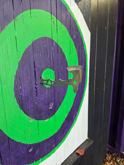 Axe stuck in a green and purple target at Radicals Rage Rooms